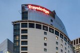 a hotel with the words travelodge in lit up letters