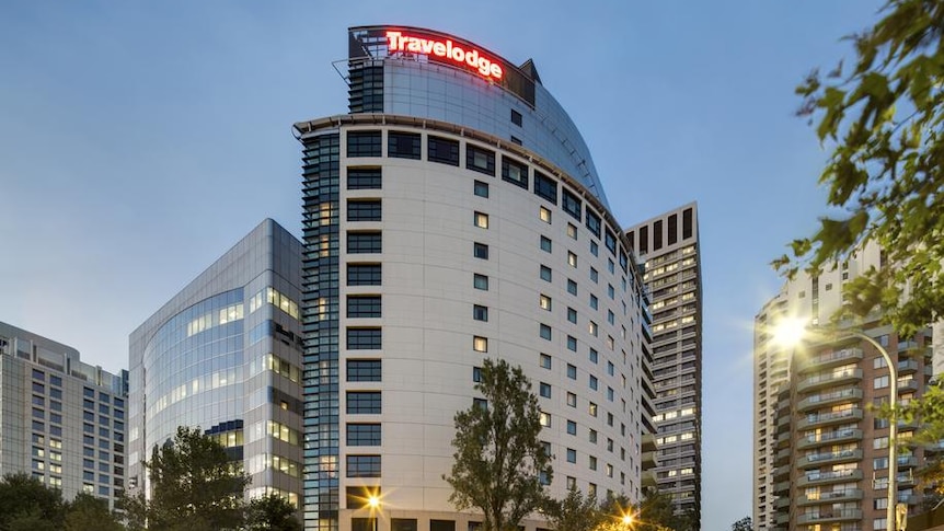 a hotel with the words travelodge in lit up letters