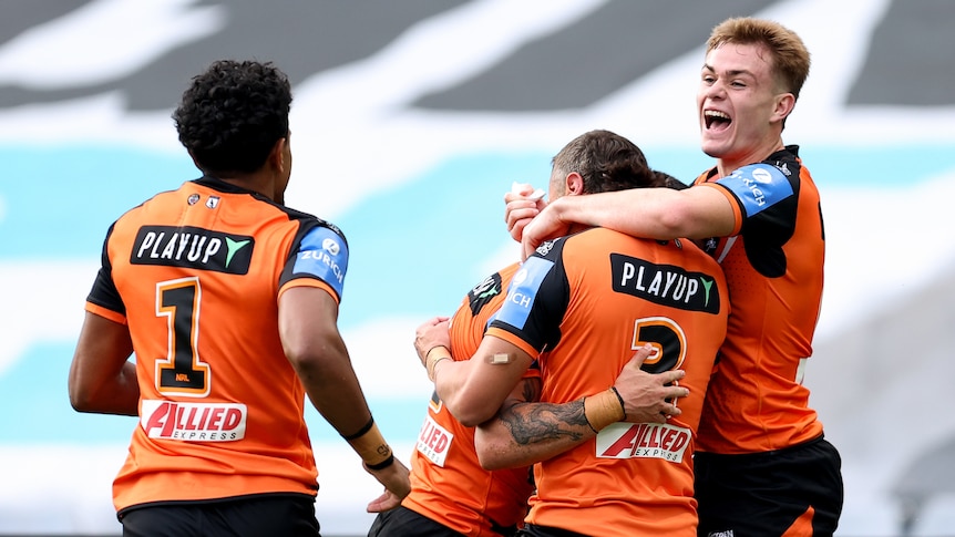 Charlie Staines celebrates with Tigers team mates