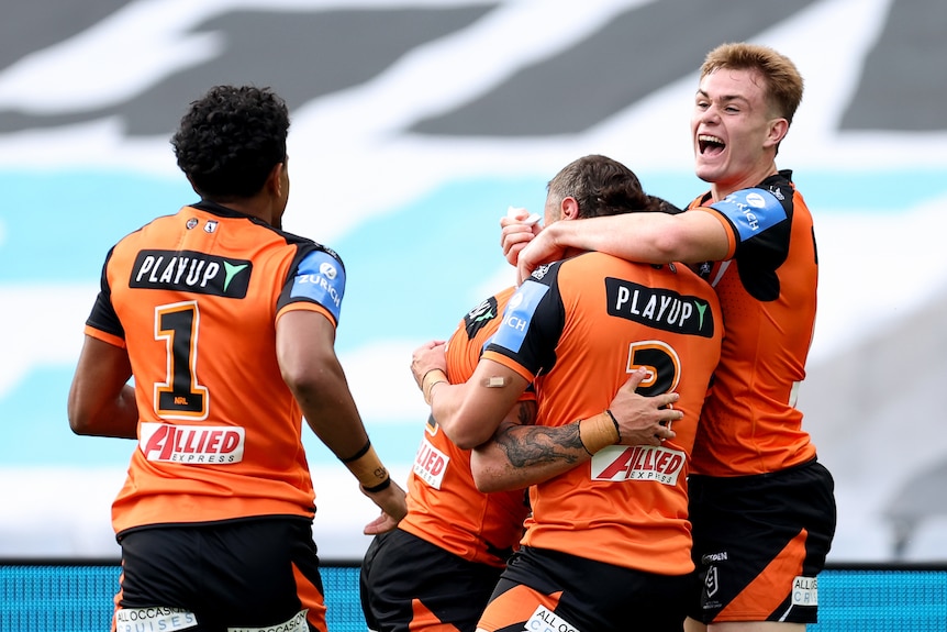 Charlie Staines celebrates with Tigers team mates