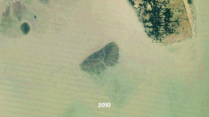 A satellite images of a small island, part of it is underwater