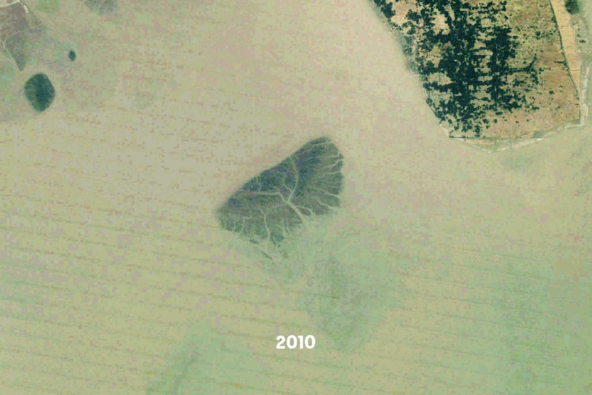 A satellite images of a small island, part of it is underwater