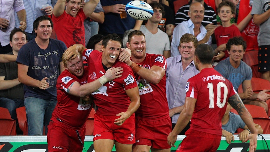 New home ... Mike Harris is congratulated on one of his two tries against the Rebels