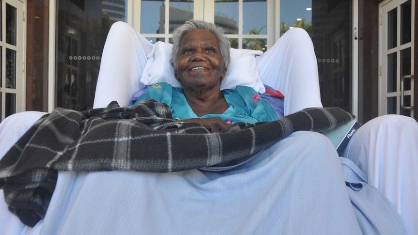 An Aboriginal elderly woman in a wheelchair.