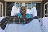 An Aboriginal elderly woman in a wheelchair.