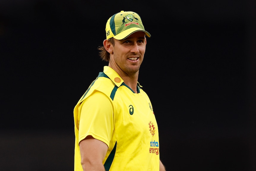 Mitch Marsh looks on wearing the gold Australian ODI kit