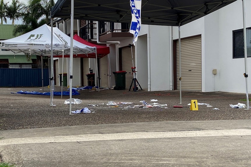 Debris strewn across the driveway with police evidence numbers next to items.