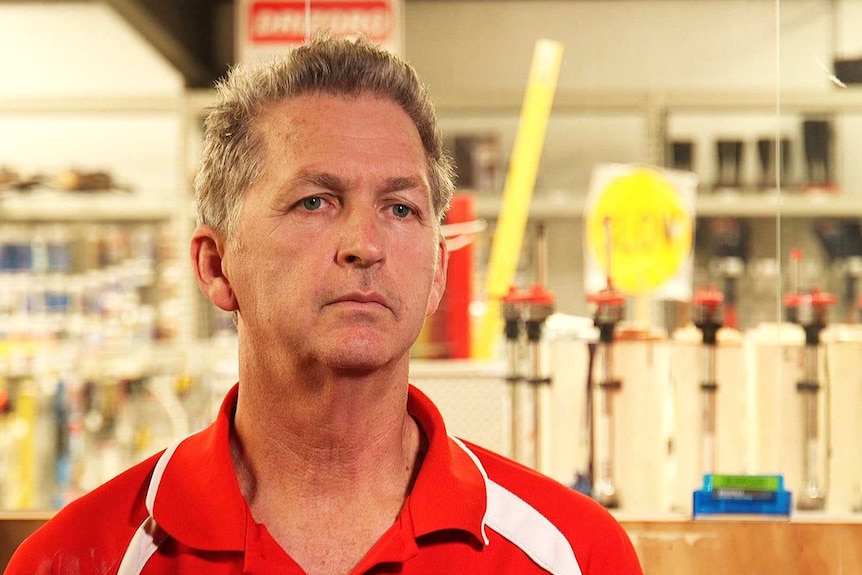 Grant Cowle stands in his hardware store.