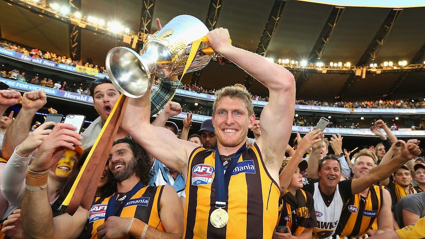 Ben McEvoy holds the cup after Hawthorn won the premiership