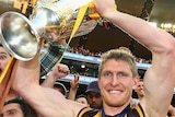 Ben McEvoy holds the cup after Hawthorn won the premiership
