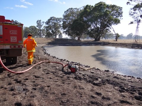 Firefighters pump water from a dam in south west Victoria.
