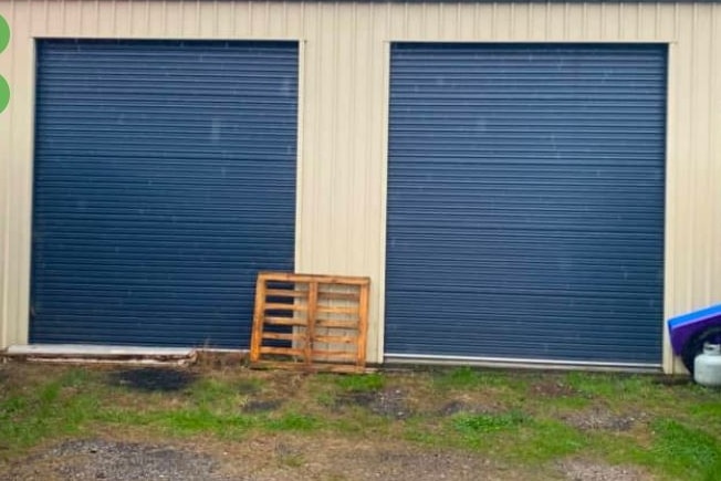 Two blue roller doors on a shed