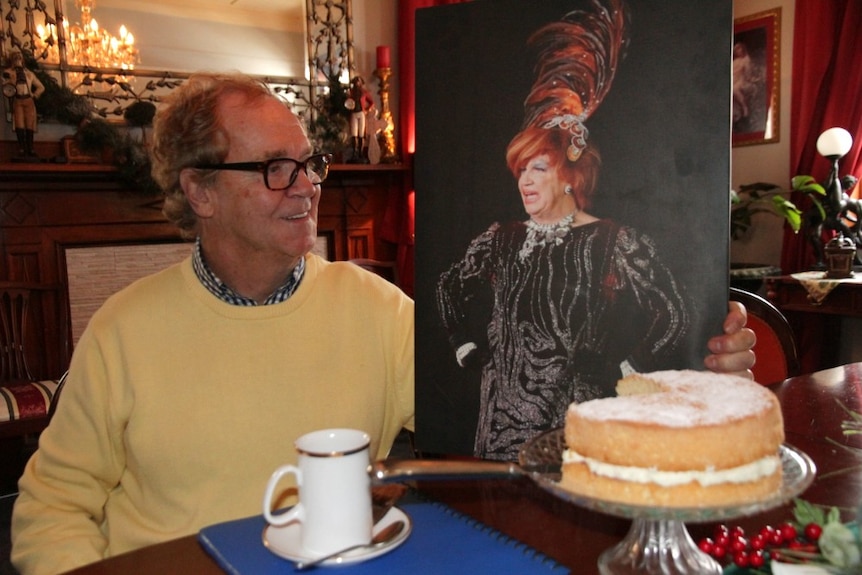 Tommy Jeffs with a canvas image of his drag queen character, Tallulah.