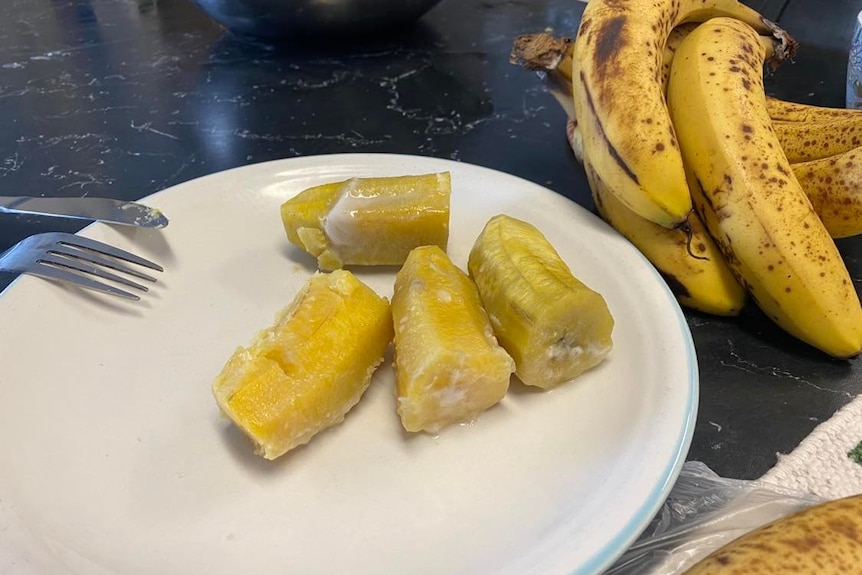 a banana covered in a coconut glaze sitting on a plate