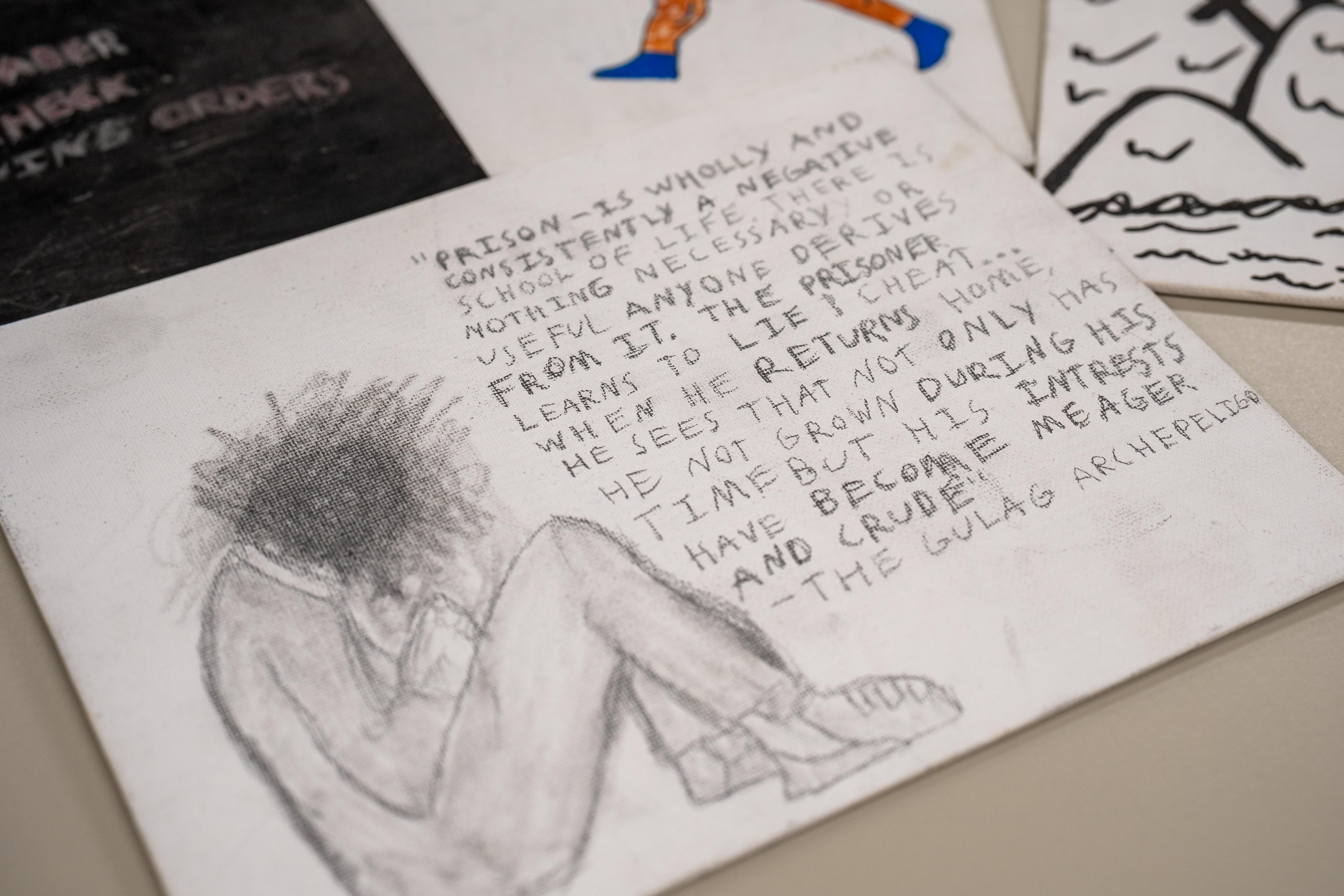 A pencil shaded drawing of a child sitting with his head in his hands in the left hand corner.