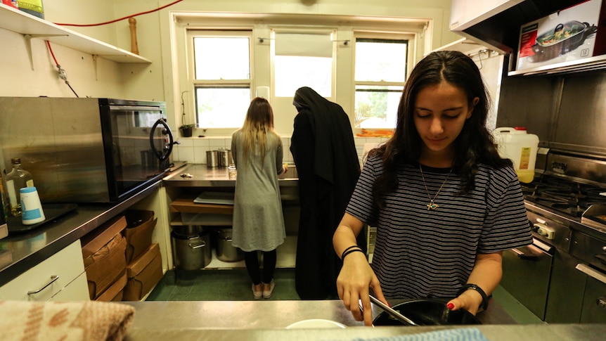 Young members of Melbourne's Coptic community help prepare food in the monastery's kitchen.