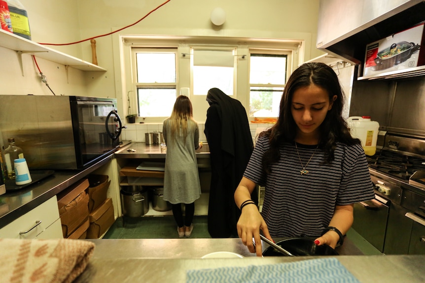 Young members of Melbourne's Coptic community help prepare food in the monastery's kitchen.