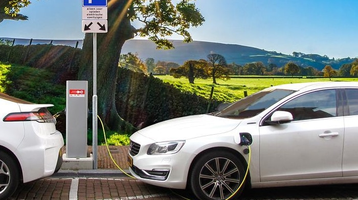 Picture of white Electric vehicle by a paddock