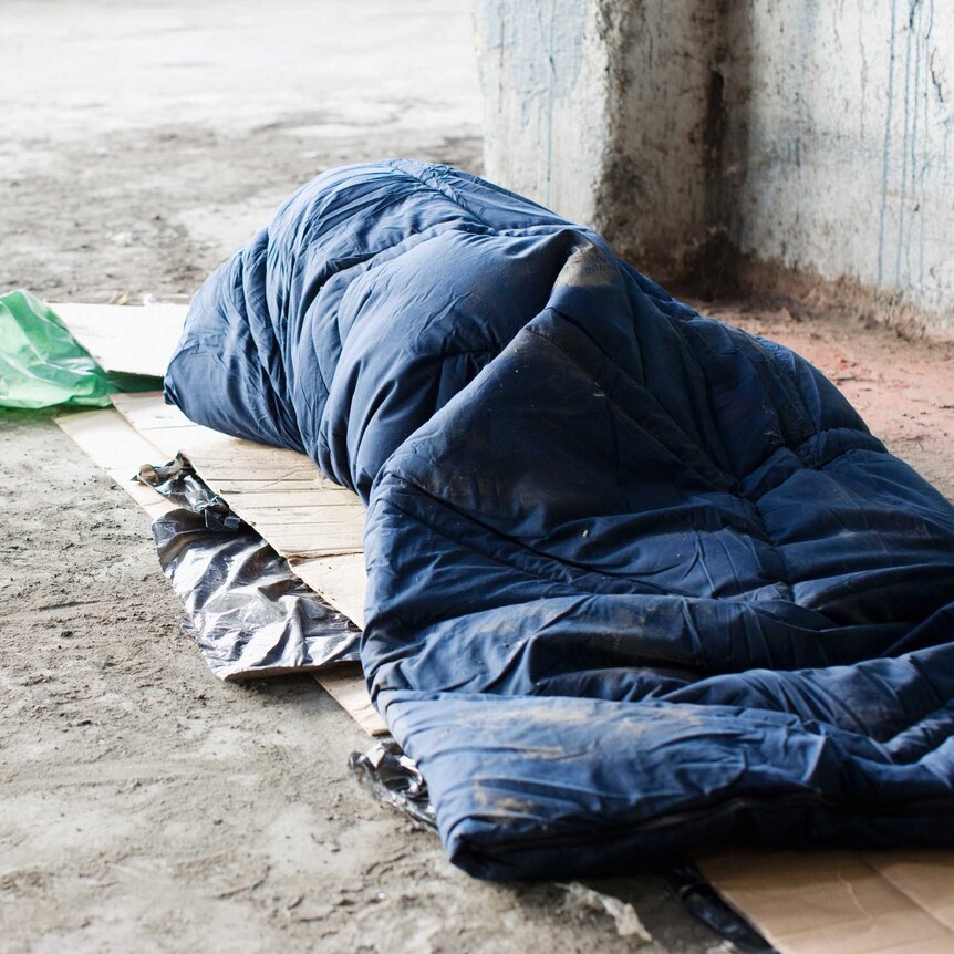 homeless person in sleeping bag