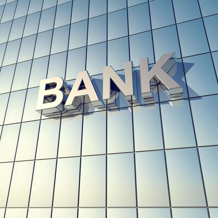 This image focusses on the shiny, blue-toned glass front of a building, and zooms in on the word "bank".