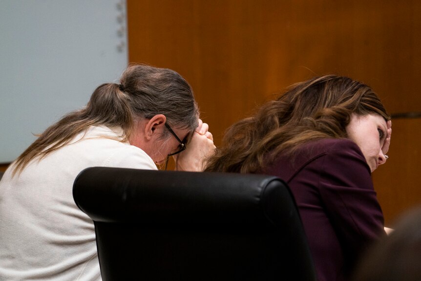 Jennifer Crumbley, left, weeps as her attorney Shannon Smith holds her head in her hands