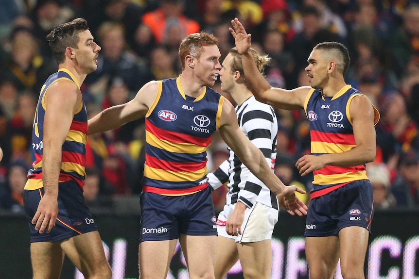 The Crows celebrate a goal against Collingwood