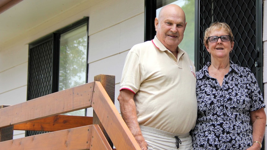 Man and woman on front stairs of a house