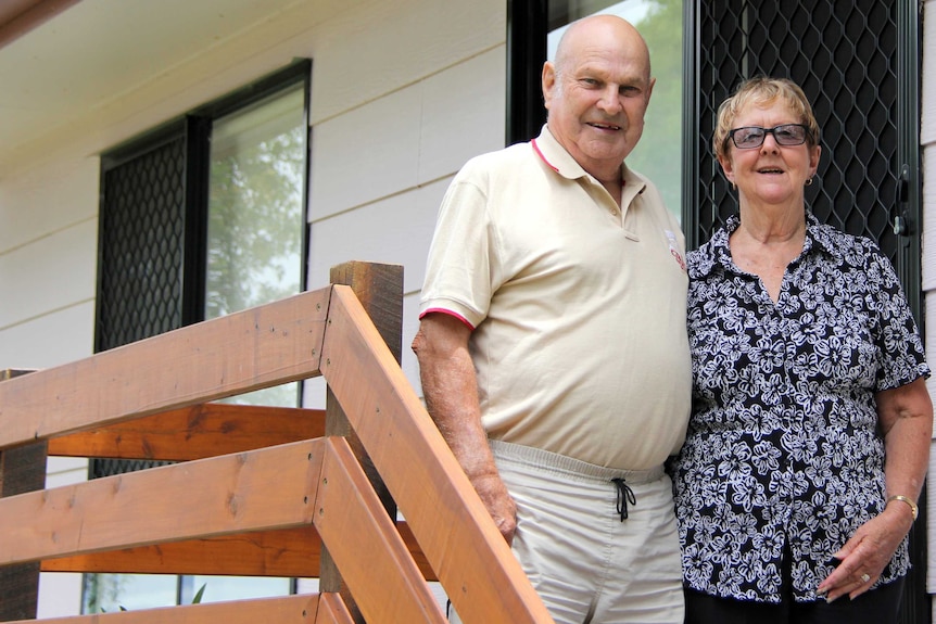 Man and woman on front stairs of a house