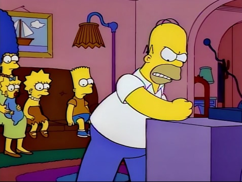 A still image from the Simpsons which shows Homer pounding his TV