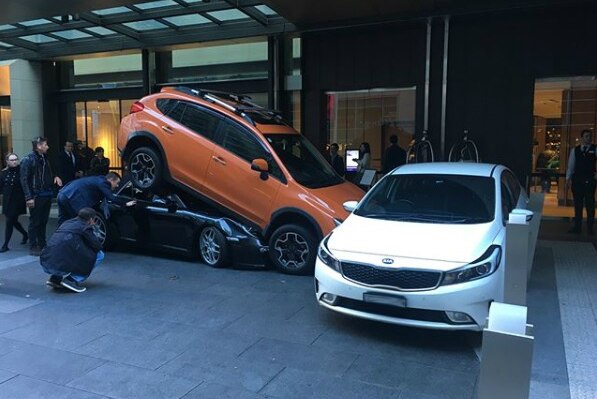 Two cars parked on top of each other outside Sydney's Hyatt Regency hotel on May 31, 2018.