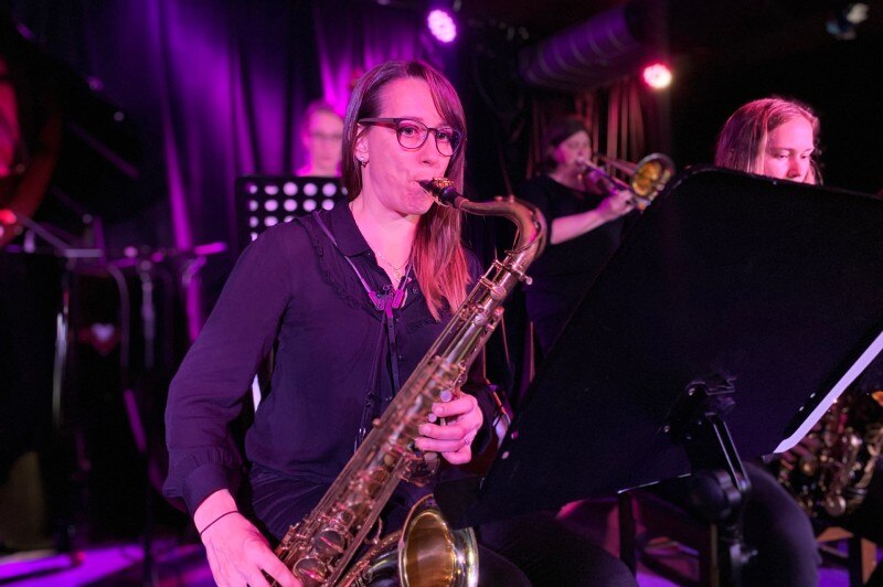 Female saxophonist performs on stage