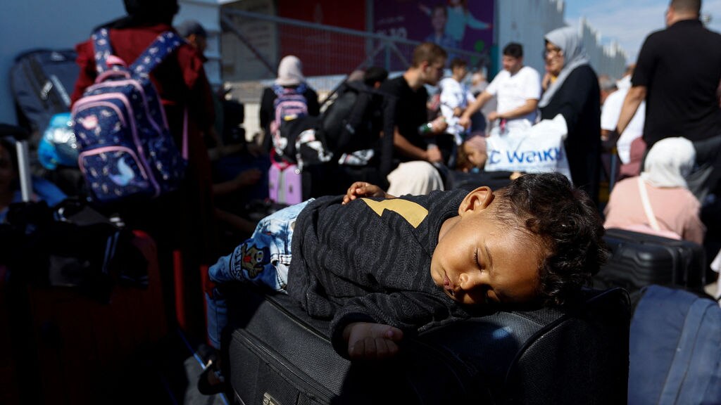 Civilians mass at Rafah crossing as aid trucks queue on other side ...