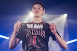 Illawarra Hawks player LaMelo Ball shows off his number one NBL jersey during a promotional photoshoot.