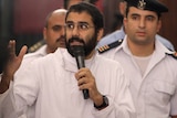 Alaa Abdel Fattah speaks in front of a judge at a court during his 2014 trial
