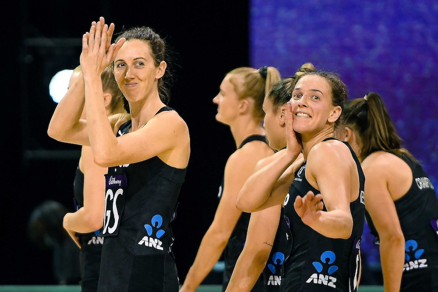 New Zealand netballers clap and smile after a Test win over Australia.