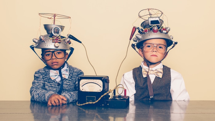 Two children with contraptions on their head to read their mind