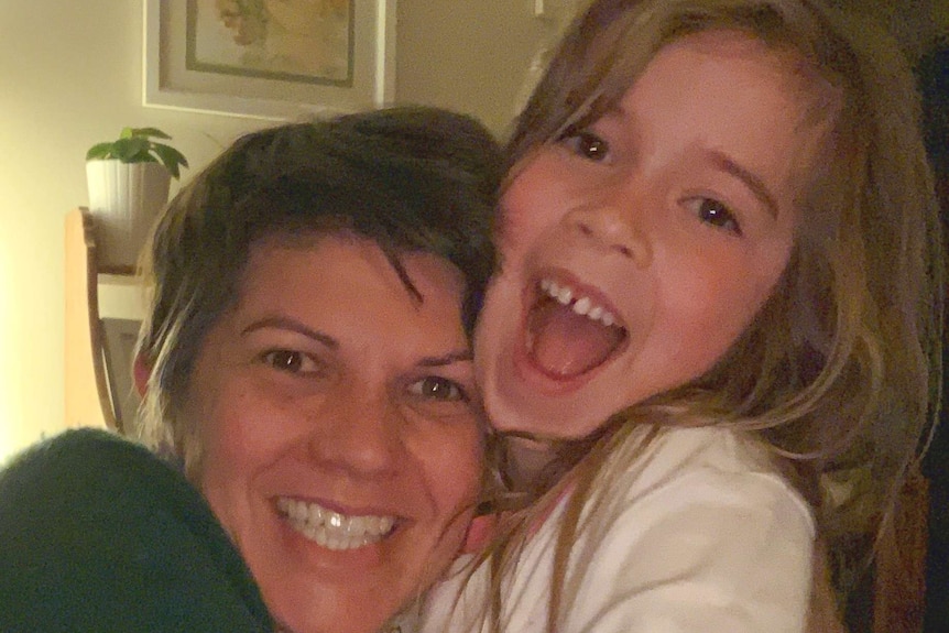 Alex and her daughter smile for a photo at home, for a story about single parents and lockdown.