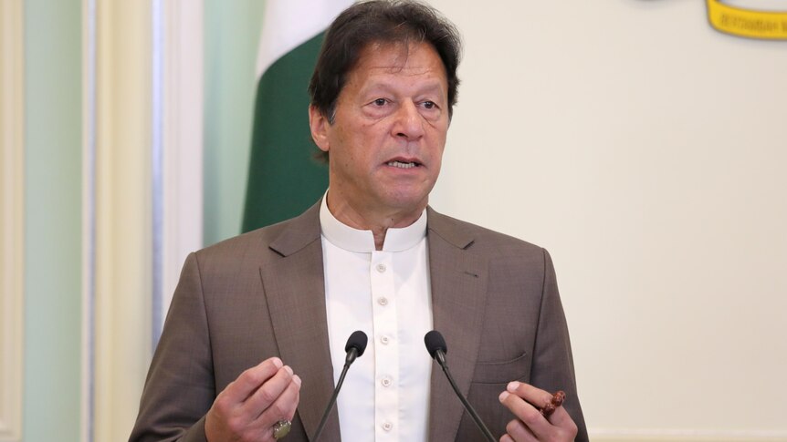 Imran Khan makes an address at a lectern. 
