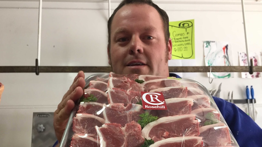 Uralla butcher Dale Goodwin holds a tray of chops