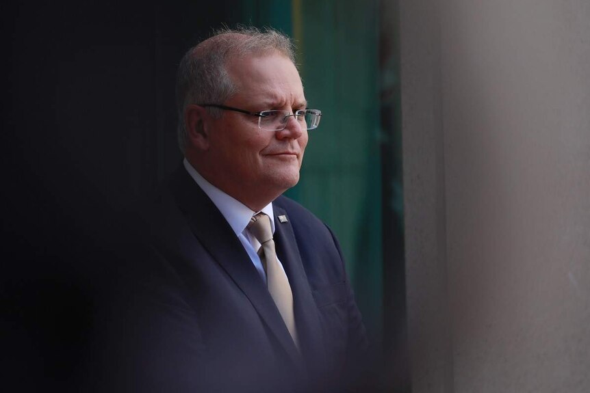 Scott Morrison, partially obscured by a shadow.