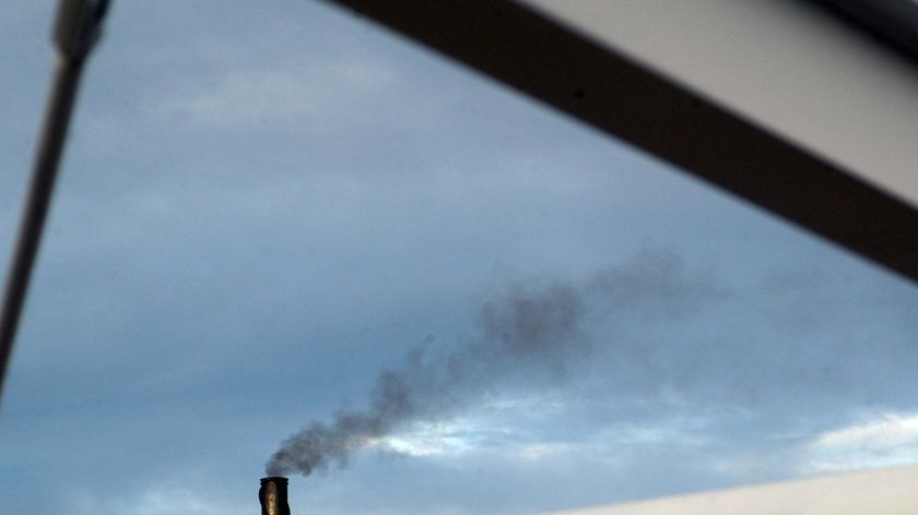 Smoke pours from an industrial chimney in Brisbane