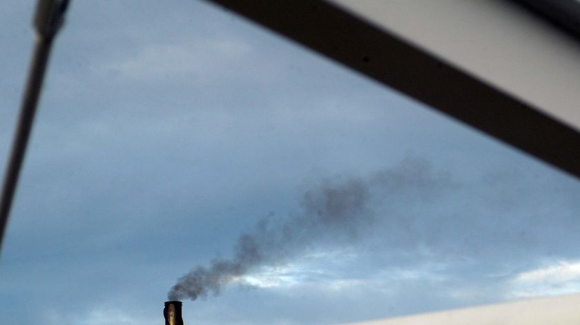 Smoke pours from an industrial chimney