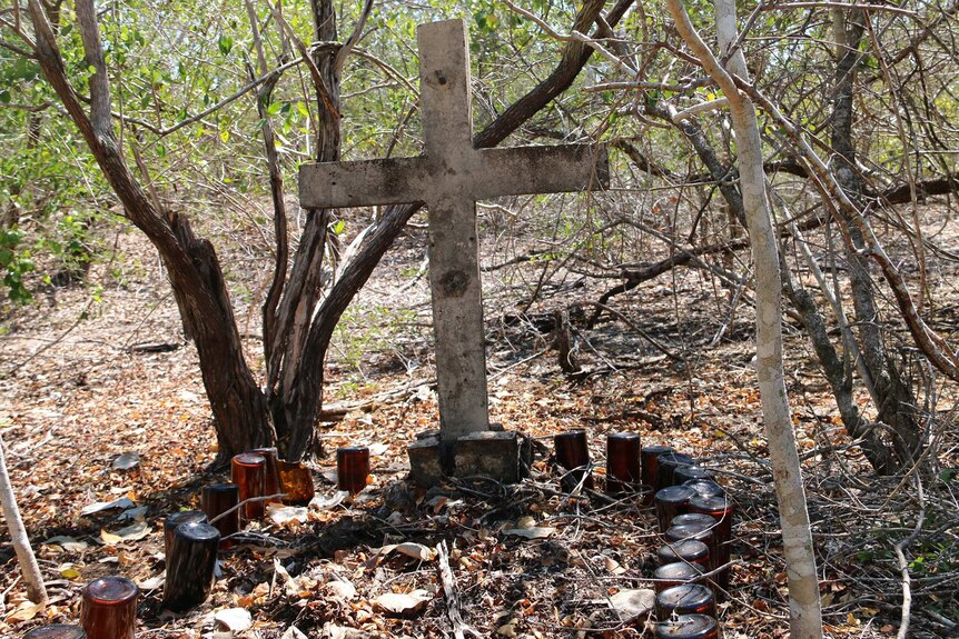 A grave site marked by beer bottles at the former leper colony at Channel Island.