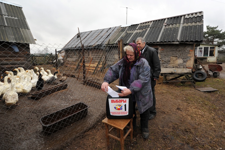 A Russian woman casts her vote in the village of Shelomets, 25 kilometres outside the western city of Smolensk.