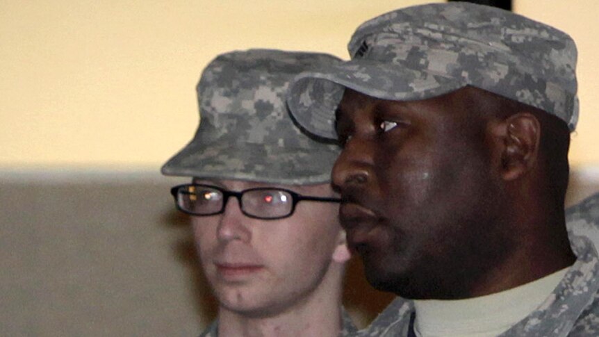 Bradley Manning (L) is escorted from the courthouse at Fort Meade on December 16, 2011.