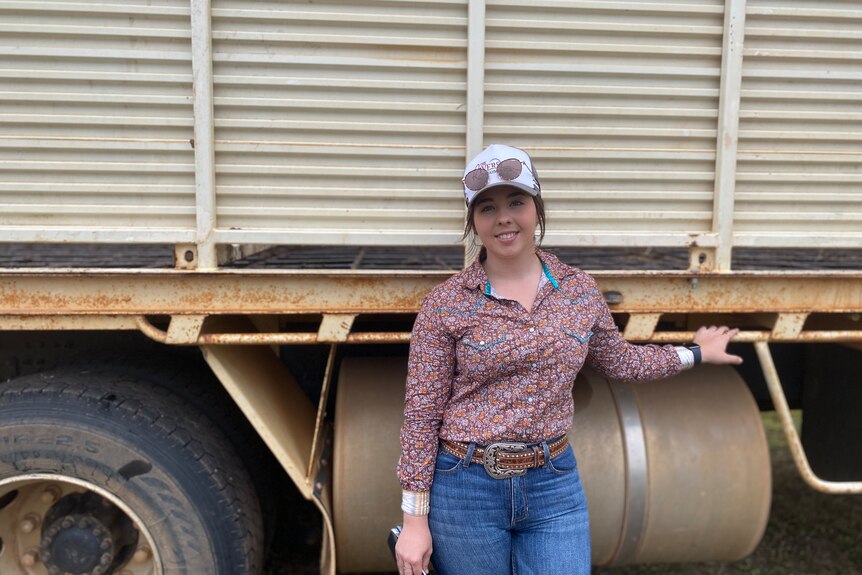 Agribusiness and animal science student Maggie Read standing in front of a cattle truck
