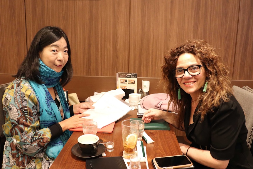 Two women at a restaurant booth