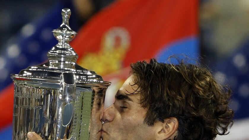 Swiss world number one Roger Federer celebrates with the US Open trophy