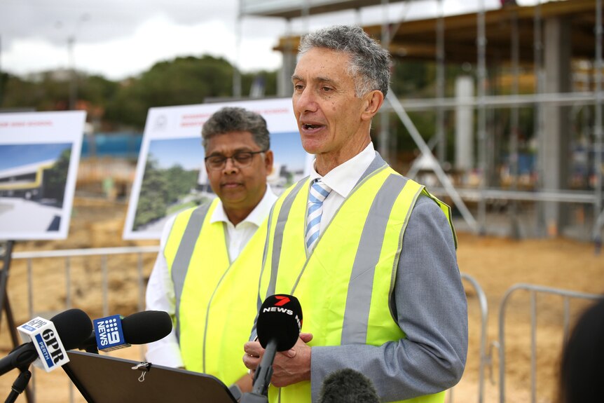 WA Education Minister Tony Buti speaking at a media conference in front of works for the Rossmoyne Senior High School upgrade.