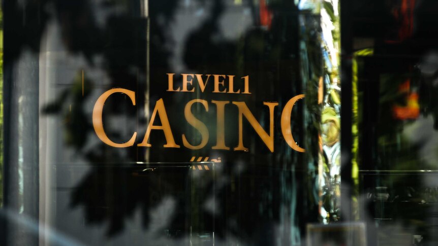 A sign on a black door in gold lettering which says level one and casino.